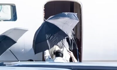 LA shielded by umbrellas